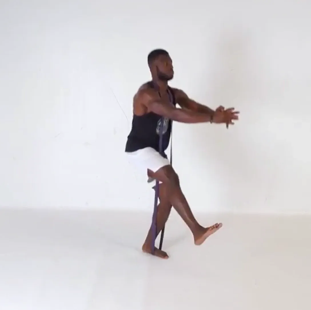 A pistol squat with a resistance band under the standing foot